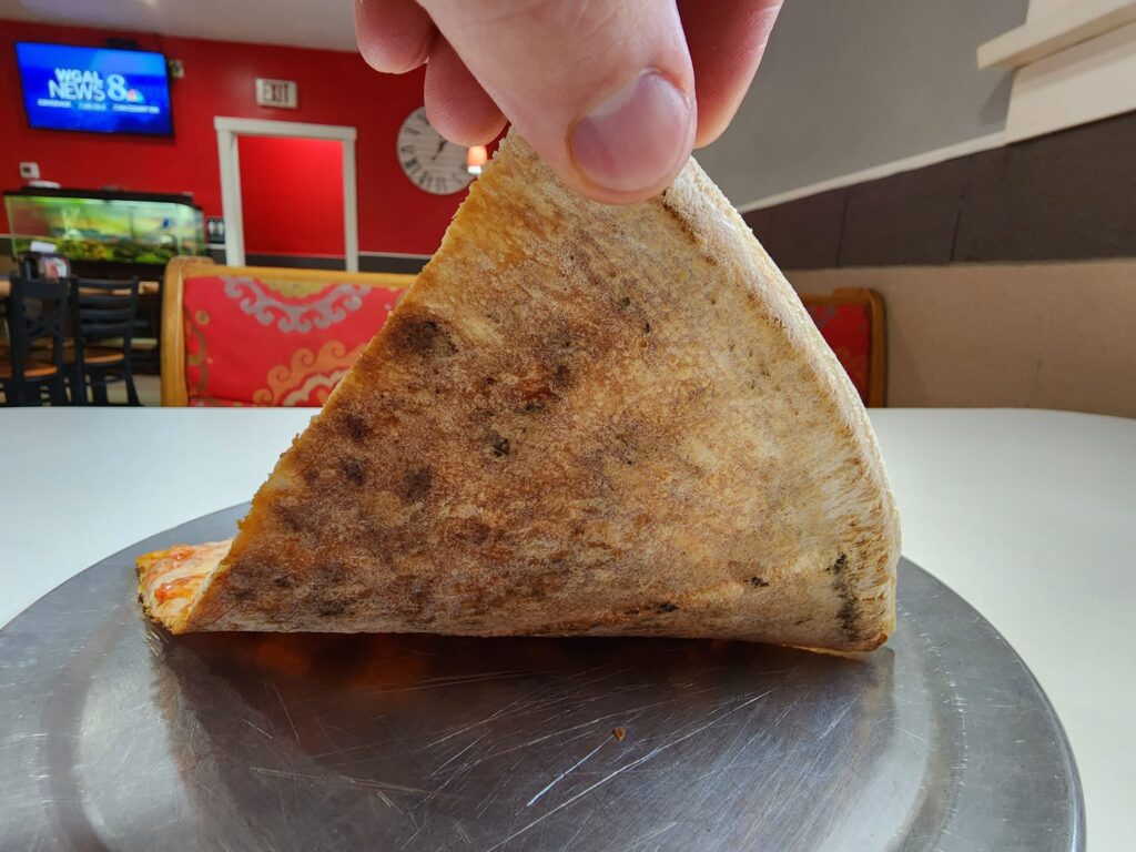 A peek at the bottom crust of a cheese slice at Two Cousins Pizza in Paradise, PA.